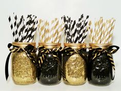 black and gold mason jars with paper straws in them