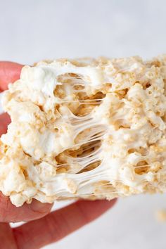 a person is holding some kind of cracker with white icing on it's side