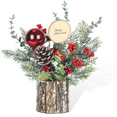 a christmas arrangement with pine cones and berries in a wooden vase on a white background