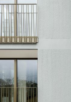 an apartment building with two balconies and windows