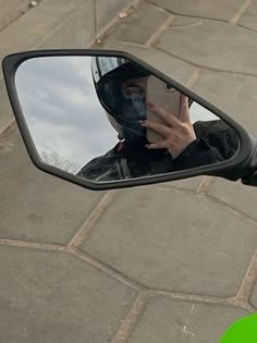 the reflection of a person in a rear view mirror