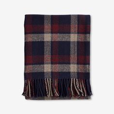 a plaid blanket with fringes on it