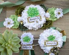 there are some flowers on the table with ribbons around them and name tags attached to it