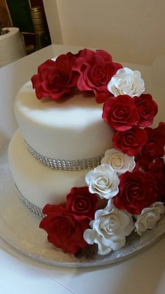 a white cake with red and white flowers on it