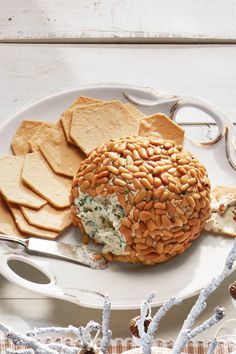 a white plate topped with crackers and hummus