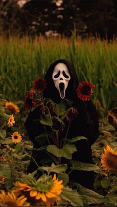 a person in a black mask with sunflowers