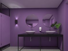 a purple bathroom with two sinks and mirrors