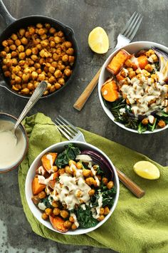 two bowls filled with chickpeas and greens next to a bowl of ranch dressing