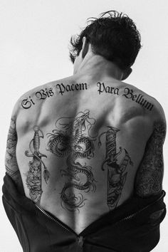 a man with many tattoos on his back