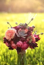 a bouquet of flowers sitting on top of a green field with the words happy sunday