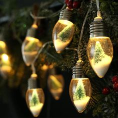 christmas lights hanging from a tree decorated with snow and evergreen trees in mason jar jars