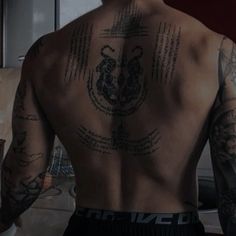 a man with many tattoos on his back