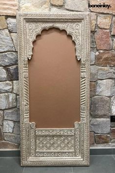 a mirror sitting on top of a stone wall