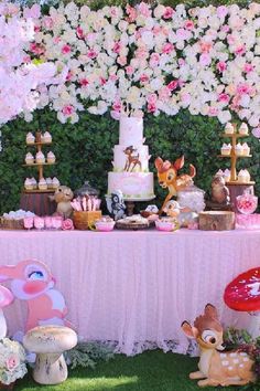 a table topped with lots of cakes and desserts