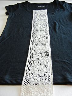 a black shirt with white lace on it