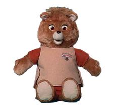 a brown teddy bear wearing a pink shirt