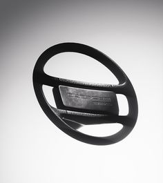 a black and white photo of a steering wheel