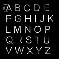 the letters and numbers are made up of small white dots on a black background,