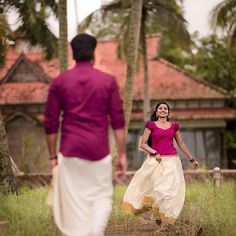 a man and woman walking down a dirt road