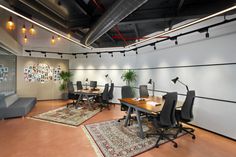 an office with chairs and rugs on the floor