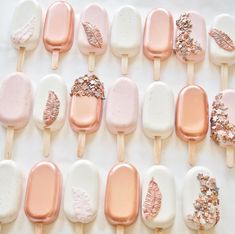 an assortment of ice creams with gold leaf decorations on them, arranged in rows