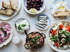 a table topped with plates and bowls filled with food