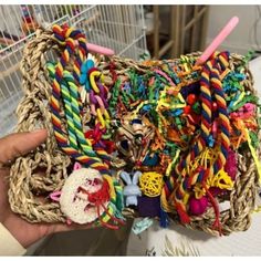 a person holding a basket filled with lots of colorful items