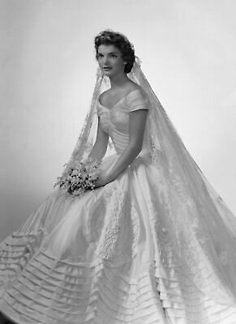 an old photo of a woman in a wedding dress