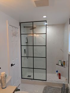 a bathroom with a shower, toilet and sink in it's center area is shown