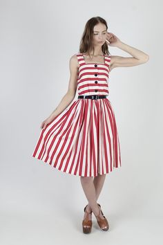 "Vintage 80s summer festival midi dress. Tailored tank bodice with button down front. Gathered elastic waist with sweeping skirt. Red and white striped cotton material. size estimate: M shoulders: - bust: 27\" - 36\" waist: 22\" - 34\" hips: - total length: 41\" * Visit the shop * https://www.etsy.com/shop/americanarchive Model is 5'9\" Belts and other accessories are not included." 80s Summer, Skirt Summer, Holiday Party Dresses, Holiday Party Outfit, White Striped Dress, Red And White Stripes, Summer Festival, Holiday Dresses, Full Skirt