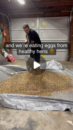 a man standing in front of a pile of grain next to an open garage door with the words and we're eating eggs from healthy hens