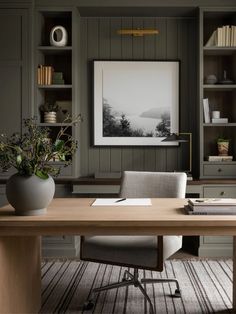 an office with gray walls and wooden desk