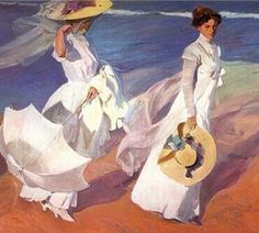 two women in white dresses and hats walking on the beach