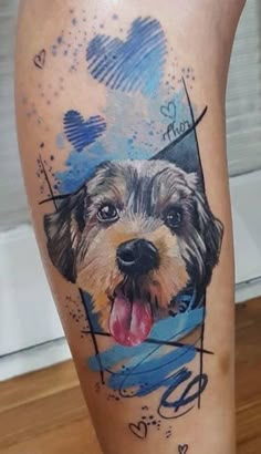 a dog with its tongue out and his face painted on the side of someone's leg