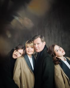 three women and one man are posing for the camera