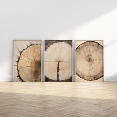 three pieces of wood sitting on top of a wooden floor next to a white wall