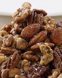 a pile of nuts sitting on top of a white plate