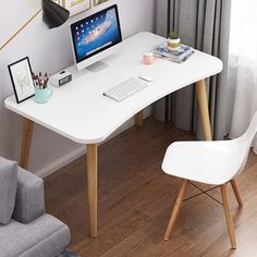 a white desk with a computer monitor and keyboard