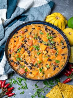 a black bean and sweet potato soup in a bowl with tortilla chips on the side