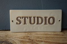 a ceramic sign that says studio on it