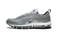 The Air Max 97 just looks right in the color silver.  Whether it's the original "Silver Bullet" colorway or this Air Max 97 Premium "Reflect Silver" the metallic shade works well across the classic runner whose design was inspired by high speed trains in Japan.  The Air Max 97 "Reflect Silver" has a mix of reflective silver and silver mesh paneling across the upper.  A Swoosh by the midfoot and the tongue is done in black, while the heel tab has "Air Max" running down it in red.  The sneaker has Senior Clothes, Skater Shoes, Nike Silver, Glitter Sneakers, Silver Bullet, Stadium Goods, Loafer Sneakers, New Nike Air, Freshman Year