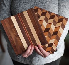 a person holding three pieces of wood in their hands