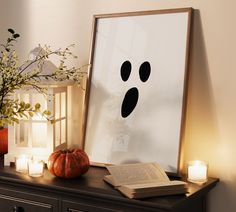 an open book sitting on top of a wooden table next to a vase filled with flowers