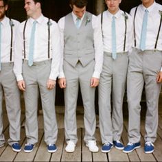 a group of men standing next to each other in front of a door wearing ties