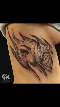 a woman with a tiger tattoo on her stomach and behind her is an image of a tiger's head