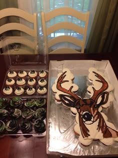 cupcakes in the shape of a deer are sitting next to an assortment of cupcakes