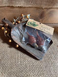 two pieces of meat sitting on top of a wooden tray next to berries and nuts