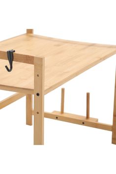 a small wooden table with an umbrella on it's end and two legs that are connected to each other