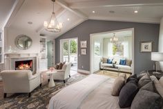 a living room filled with furniture and a fire place in the middle of it's walls