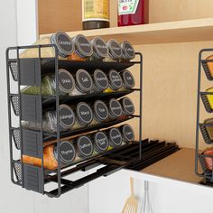 an organized spice rack in the kitchen with spices and seasonings on shelves next to utensils